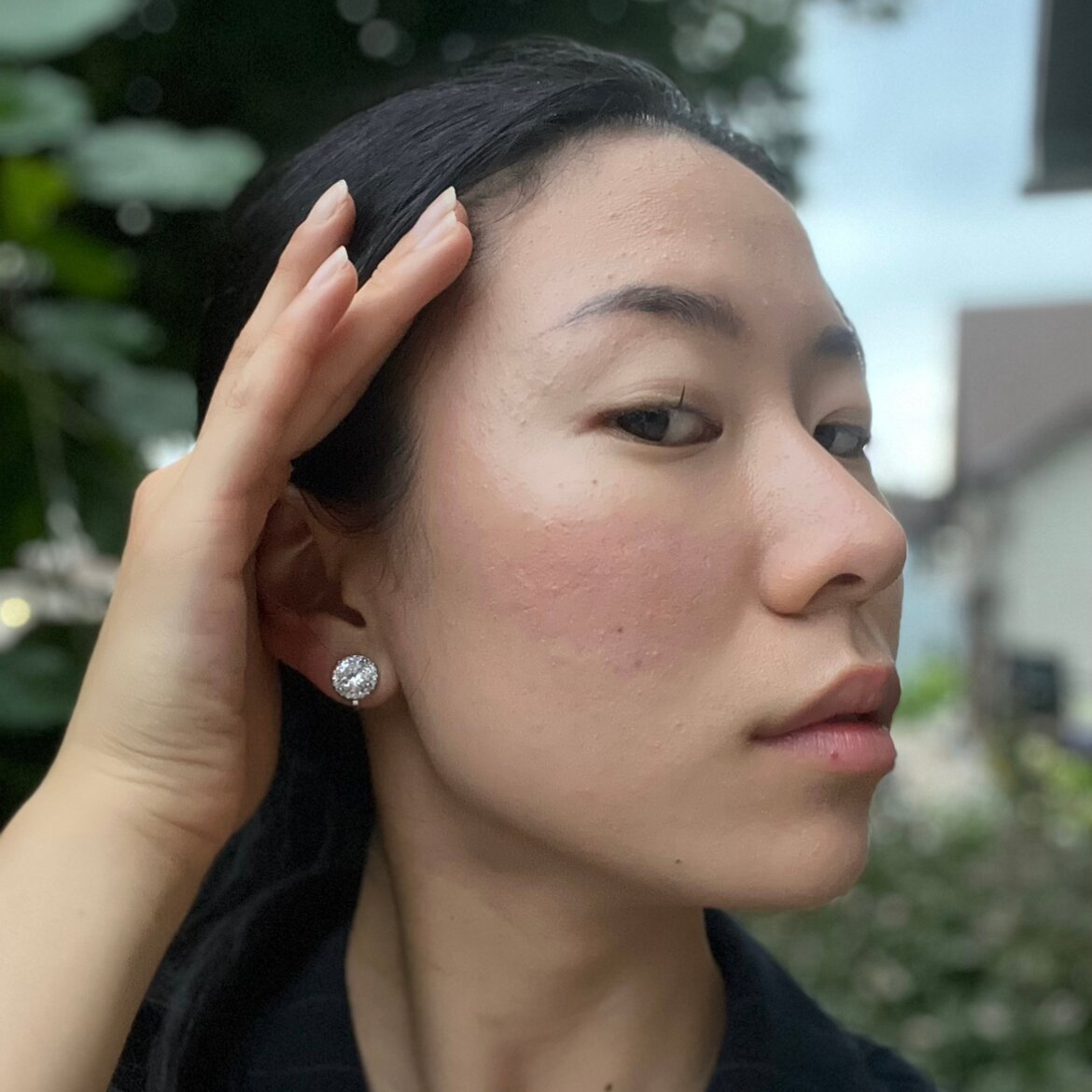 A model wearing the Harper Stud clip-on earrings features a secure hold, with a maximum comfortable wear duration of 8 to 12 hours. It is ideal for all ear types, including thick/large, sensitive, small/thin, and stretched/healing types. It is made with a silver-tone copper alloy and cubic zirconia, and comes with a removable rubber padding for added comfort. Please note: only one pair is included.