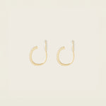 Image of the Medium Pavé Hoop Clip On Earrings in Gold offer a Mosquito Coil Clip-On Closure, making them ideal for Thick/Large Ears, Sensitive Ears, Small/Thin Ears, Stretched/Healing Ears, and Keloid Prone Ears. They provide an average comfortable wear duration of 24 hours with a medium secure hold, and can be gently adjusted by squeezing the padding forward once on the ear. Please note that this item is only one pair.