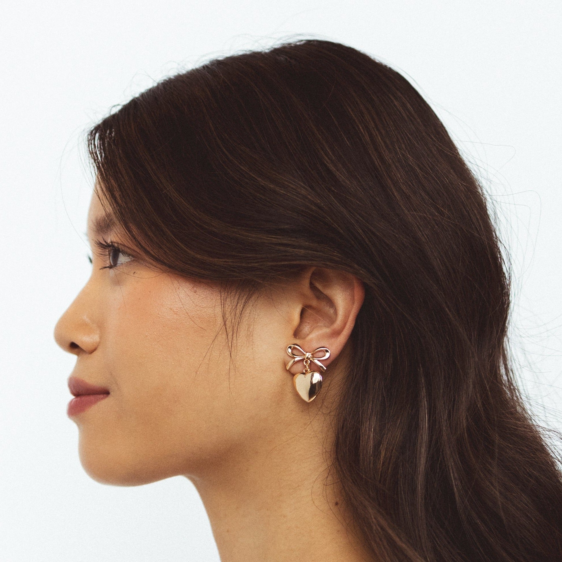 A model wearing the Venus Clip On Earrings. Specially designed for sensitive or stretched ears, these earrings ensure a secure 24-hour hold and customizable fit for unmatched comfort. Elevate your style with effortless elegance.