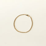 Image of the Tennis Bracelet is an exquisite companion to its sister piece, the Classic Tennis Necklace. Meticulously constructed from 14K gold plated metal, it is embellished with shimmering Cubic Zirconia stones. Additionally, its design is exceptionally enduring - it is tarnish-resistant, water-resistant, nickel-free, and hypoallergenic.