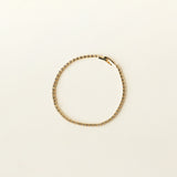 Image of the Tennis Bracelet is an exquisite companion to its sister piece, the Classic Tennis Necklace. Meticulously constructed from 14K gold plated metal, it is embellished with shimmering Cubic Zirconia stones. Additionally, its design is exceptionally enduring - it is tarnish-resistant, water-resistant, nickel-free, and hypoallergenic.