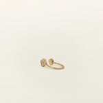 Image of the Gold Clover Ear Cuff, a chic and versatile accessory. Made from Gold or Silver Plated Copper alloy, this modern clover-shaped ear cuff features 4 sparkling Cubic Zirconia stones. Ideal for both the nose and ear, it effortlessly adds sophistication to any outfit, allowing you to adorn yourself with style and flair.
