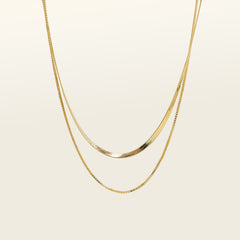 Image of the Double Layered Chain Necklace In Gold. This necklace features an adjustable design, and is crafted from 18K Gold Plated Vermeil on Sterling Silver with waterproof and non-tarnish properties. It is also available in Silver.