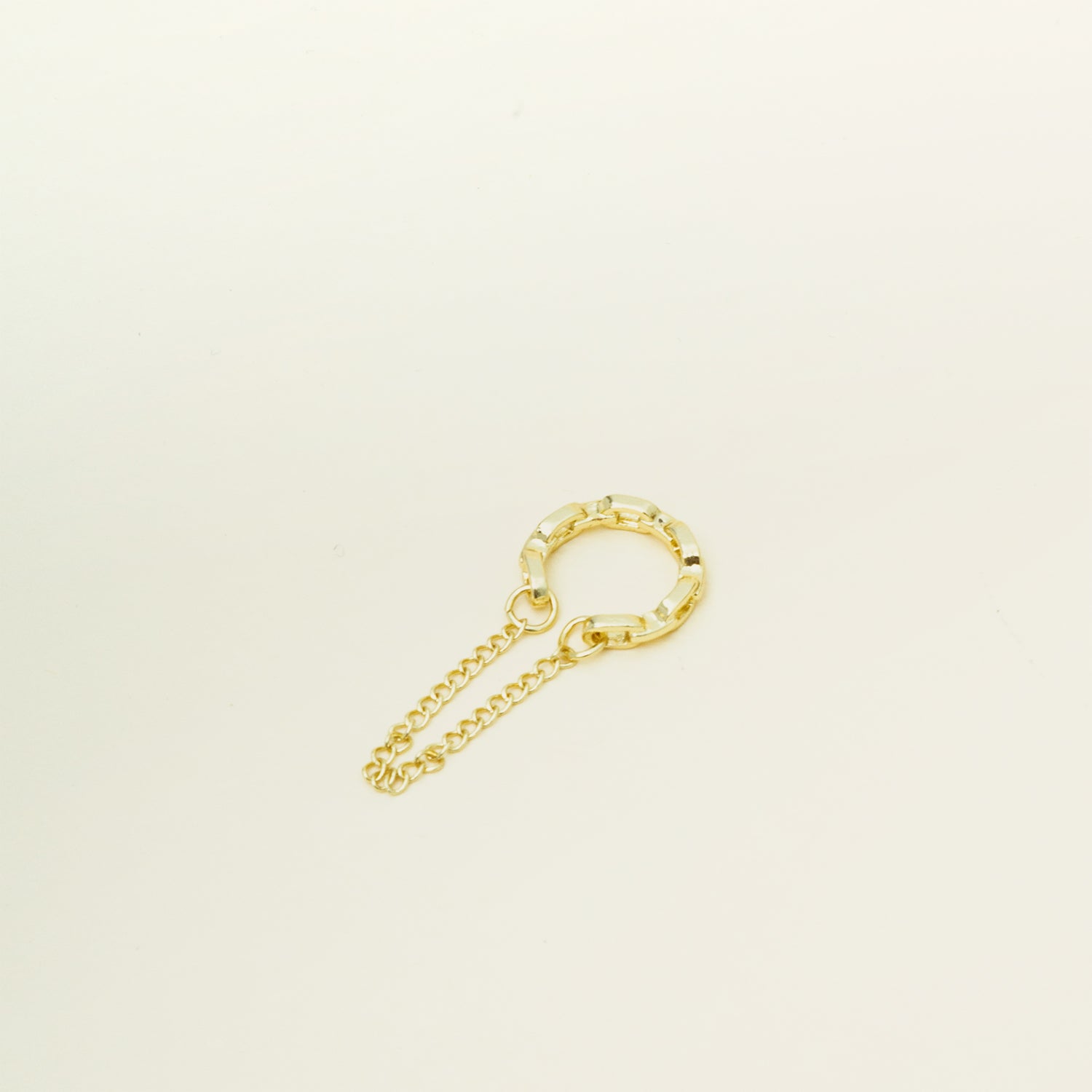 Catalogue Image of a modern Dual Chain Ear Cuff crafted from Goldtone or Silvertone plated zinc alloy. This trendy accessory features a delicate chain, designed to elegantly adorn the earlobe of both men and women.