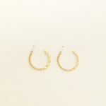 Image of the Gold Talia Hoop Clip-On Earring features a resin clip-on closure that is ideal for all ear types, providing a medium secure hold and an average comfortable wear duration of 8-12 hours. It is not adjustable, and is also available in Silver. The earrings are constructed with a gold tone metal alloy.