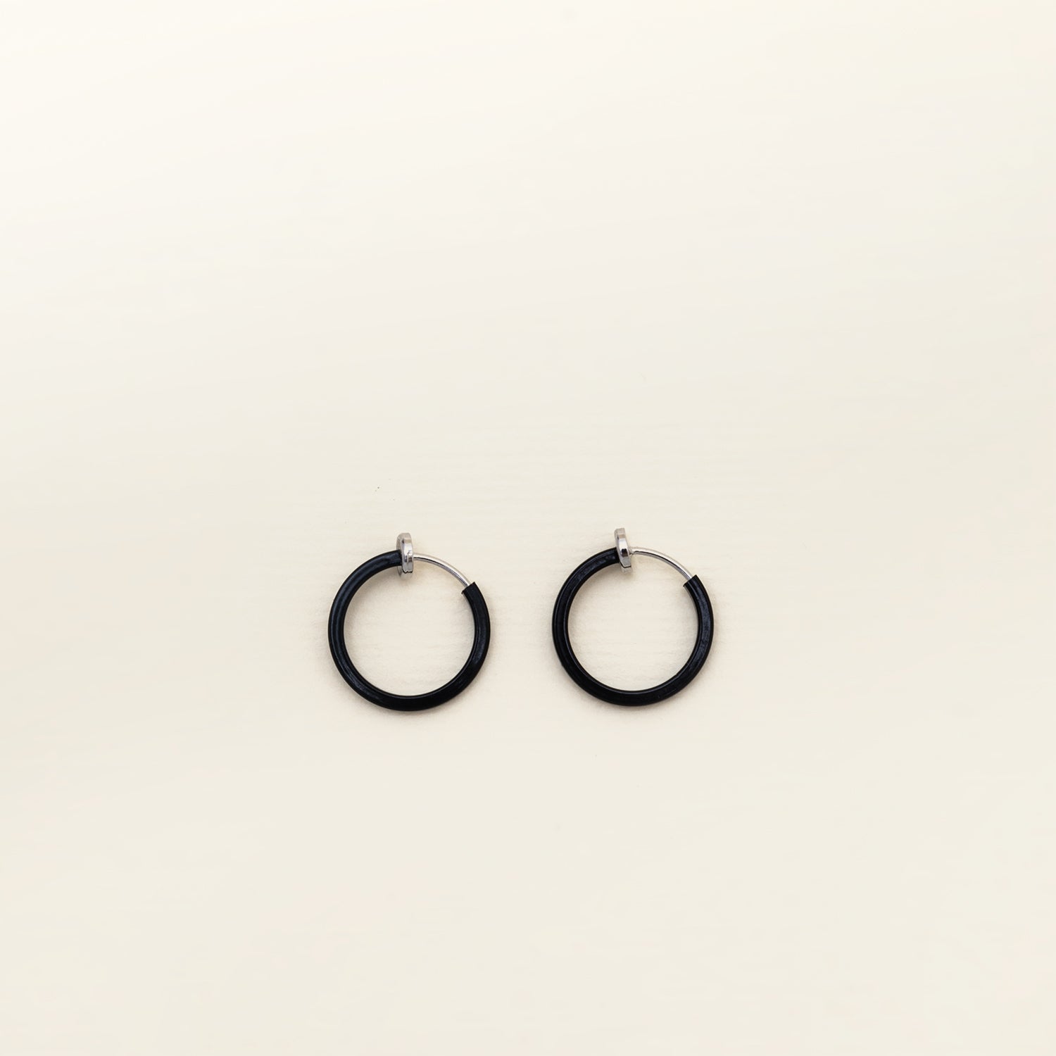 Image of the Mini Hoop Clip-On Earrings feature a sliding spring closure and are best suited for those with smaller or thinner ear lobes. On average, each pair can be comfortably worn for up to 4 hours, and provide a very secure hold that automatically adjusts to the ear thickness for a perfect fit. Crafted with stainless steel, each pair is sold individually.