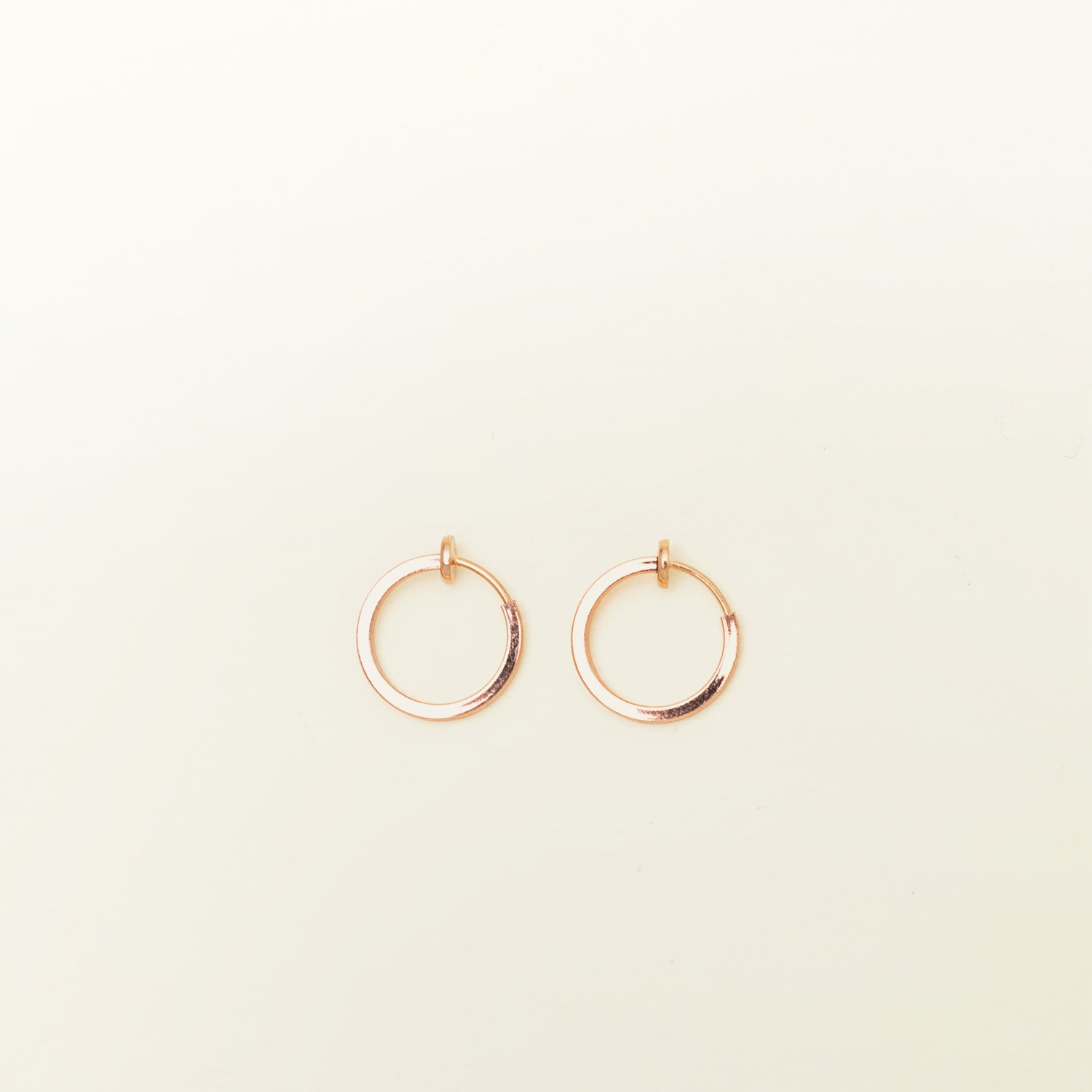 Image of the Mini Hoop Clip-On Earrings feature a sliding spring closure and are best suited for those with smaller or thinner ear lobes. On average, each pair can be comfortably worn for up to 4 hours, and provide a very secure hold that automatically adjusts to the ear thickness for a perfect fit. Crafted with stainless steel, each pair is sold individually.