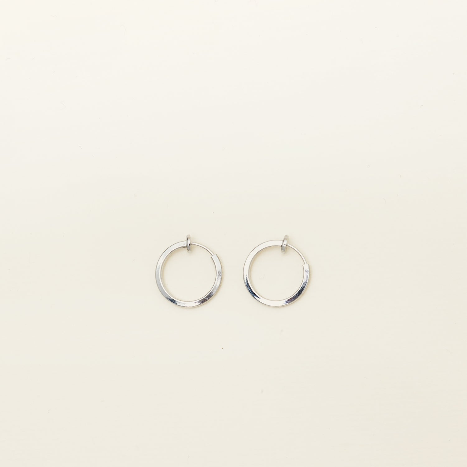 Image of the Mini Hoop Clip-On Earrings feature a sliding spring closure and are best suited for those with smaller or thinner ear lobes. On average, each pair can be comfortably worn for up to 4 hours, and provide a very secure hold that automatically adjusts to the ear thickness for a perfect fit. Crafted with stainless steel, each pair is sold individually.