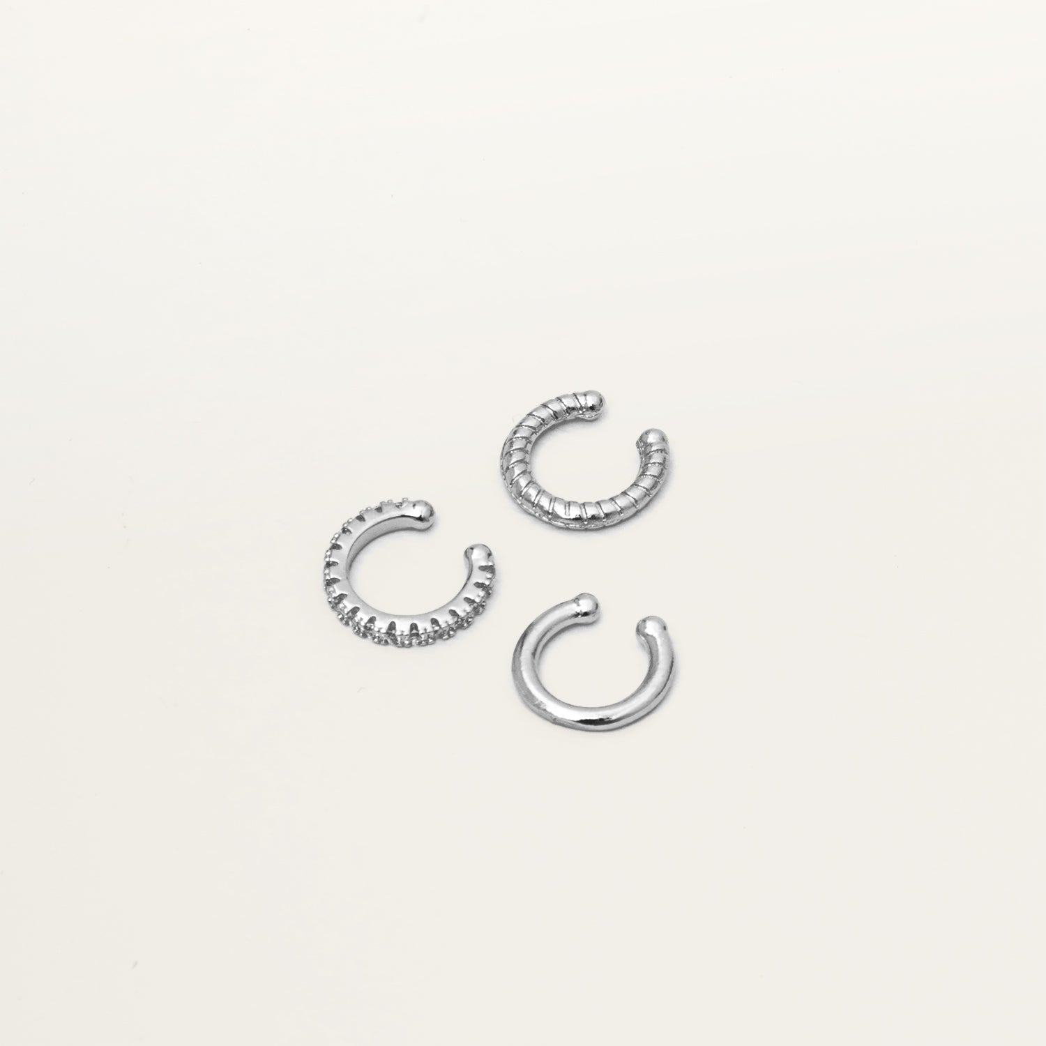 Image of the Silver Trio Ear Cuffs Set is composed of silver tone plated alloy and Cubic Zirconia. It is supplied with three pieces, and a Gold version is available. Each ear cuff is secured with a closure so you can wear securely and comfortably.