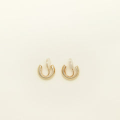 Image of the Simple Gold Huggie Clip-On Earrings feature a mosquito coil closure ideal for all ear types, providing a medium-secure hold and comfortable wear for up to 24 hours. These earrings can be adjusted with a gentle squeeze of the padding forward once on the ear. Crafted with Gold tone plated copper alloy, these sophisticated earrings are also available in Silver.
