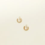 Image of the Simple Gold Huggie Clip-On Earrings feature a mosquito coil closure ideal for all ear types, providing a medium-secure hold and comfortable wear for up to 24 hours. These earrings can be adjusted with a gentle squeeze of the padding forward once on the ear. Crafted with Gold tone plated copper alloy, these sophisticated earrings are also available in Silver.