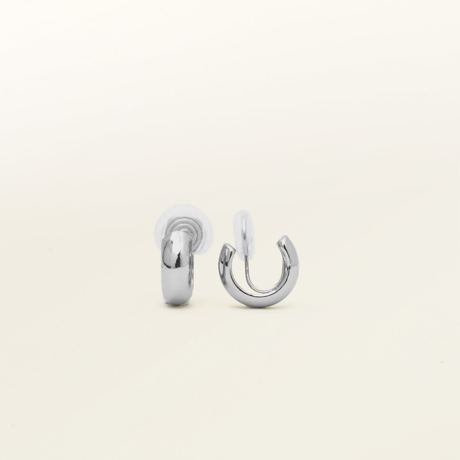 Image of the Simple Silver Huggie Clip-On Earrings provide a medium secure hold, making them perfect for all ear types. With adjustable padding for extra comfort, these earrings can be worn for up to 24 hours with ease. Crafted from copper alloy, they are also available in a gold finish.