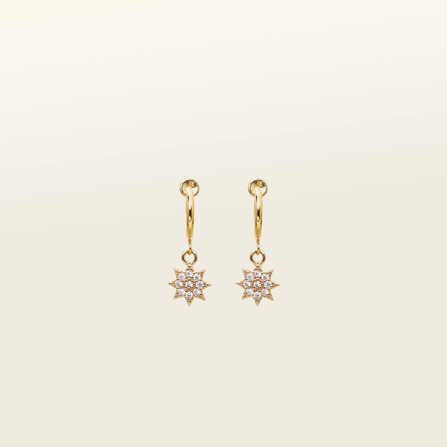 Image of the Star Charm Clip On Earring is designed with a sliding spring mechanism, ideal for those with smaller or thinner ear lobes. You can rely on a secure hold that can adjust to your ear thickness. Wear these earrings comfortably for 2 - 4 hours. Crafted from brass and cubic zirconia, this earring is sold as a single pair.