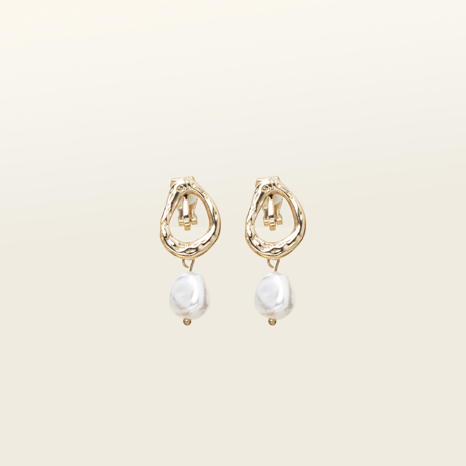 Image of the Ella Pearl Clip-On Earrings provide a secure fit for all ear types, including thick/large ears, sensitive ears, small/thin ears, and stretched/healing ears. Enjoy comfortable wear of up to 12 hours without needing to make any adjustments. Crafted with gold tone plated zinc alloy and a faux pearl, each earring has a removable rubber padding for a snug fit. Please note that the item is sold as one pair.