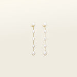 Image of the Lune Pearl Clip-On Earrings in Gold feature a unique, secure mosquito coil clasp. They are ideal for all ear types, from thick and large ears to sensitive and small. With medium hold strength, the earrings can be comfortably worn up to 24 hours and easily adjusted. Crafted with freshwater pearls, each pair may display natural variations in size and color. Materials include freshwater pearl and 18K gold-plated stainless steel.