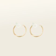 Image of the Gold Cassie Hoop Clip-On Earrings feature a resin closure, making them ideal for all ear types, including thick/large ears, sensitive ears, small/thin ears, and stretched/healing ears. On average, pairs are comfortably worn for 8-12 hours with a medium secure hold, and they are not adjustable. This item is sold as a single pair and is also available in Silver. The earrings are constructed with gold-tone metal alloy.