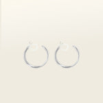 Image of the Silver Cassie Hoop Clip-On Earrings have a resin clip-on closure type and are suitable for all ear types, from thick/large ears to small/thin ears and stretched/healing ears. On average, comfortably wear for 8-12 hours, with a medium secure hold. Unfortunately, these earrings are unable to be adjusted. Offered in Silver Tone metal alloy, the earrings also come in Gold.