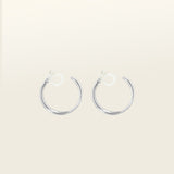 Image of the Silver Cassie Hoop Clip-On Earrings have a resin clip-on closure type and are suitable for all ear types, from thick/large ears to small/thin ears and stretched/healing ears. On average, comfortably wear for 8-12 hours, with a medium secure hold. Unfortunately, these earrings are unable to be adjusted. Offered in Silver Tone metal alloy, the earrings also come in Gold.