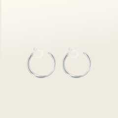 Image of the Silver Cassie Hoop Clip-On Earrings have a resin clip-on closure type and are suitable for all ear types, from thick/large ears to small/thin ears and stretched/healing ears. On average, comfortably wear for 8-12 hours, with a medium secure hold. Unfortunately, these earrings are unable to be adjusted. Offered in Silver Tone metal alloy, the earrings also come in Gold.