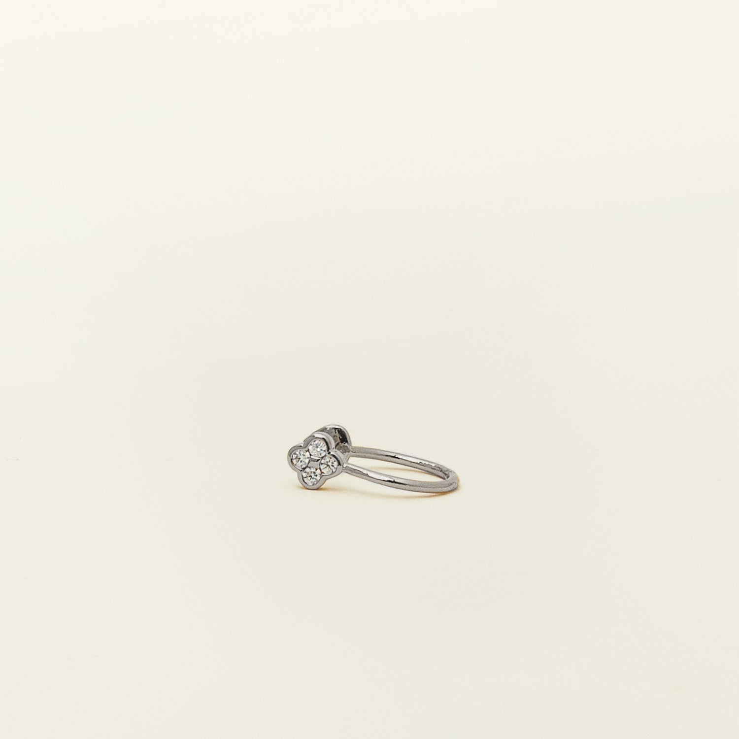 Image of the Silver Clover Ear Cuff, a chic and versatile accessory. Made from Gold or Silver Plated Copper alloy, this modern clover-shaped ear cuff features 4 sparkling Cubic Zirconia stones. Ideal for both the nose and ear, it effortlessly adds sophistication to any outfit, allowing you to adorn yourself with style and flair.