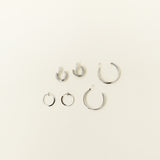 Image of the Everyday Essentials Set features three closure types: invisible resin, sliding spring and mosquito coil. It includes a Simple Silver Huggie Clip-On, Mini Hoop Earrings and Silver Cassie Hoop Earrings. Crafted from copper alloy, stainless steel and silver tone metal alloy, this item comes with three pairs and is also available in Gold.