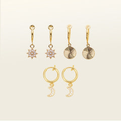 Image of the Celestial Earrings Stack Set, particularly suited to those with delicate or slender earlobes. Expertly crafted from brass and punctuated with glimmering cubic zirconias, this set features the Sunbeam Clip On Earrings, Star Charm Clip On Earrings, and Moon Charm Clip On Earrings.